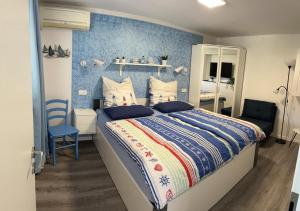 a bedroom with a bed and a blue wall at Apartment Emma in Piran