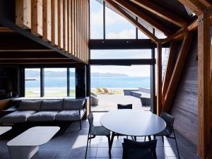 a living room with a couch and a table at CAP MARTIN Funny house in Kyonan