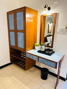 a bathroom with a dressing table and a mirror at Olive Calangute Mira - by Embassy Group in Calangute