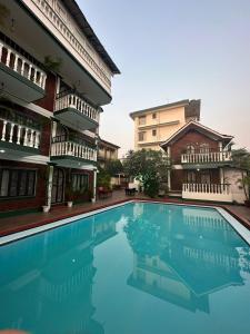 a swimming pool in front of a building at Olive Calangute Mira - by Embassy Group in Calangute