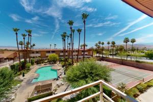 a view of a tennis court and a tennis court at Kitschy Rich Palm Springs Permit #60096 in Palm Springs
