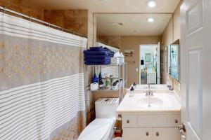 a bathroom with a toilet and a sink and a shower at Kitschy Rich Palm Springs Permit #60096 in Palm Springs +3 photos