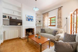 a living room with a couch and a table at Villa Can Joan den Coves in Santa Gertrudis de Fruitera