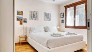 a white bedroom with a white bed and a window at Italianway Comfort - Salasco 18 in Milan