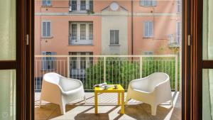 a balcony with two chairs and a table at Italianway Comfort - Salasco 18 in Milan