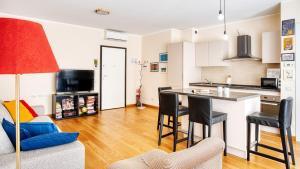 a kitchen and living room with a table and chairs at Italianway Comfort - Salasco 18 in Milan +27 photos
