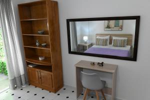 a bedroom with a mirror and a desk and a bed at Evelyn's Cozy Apartment in Rhodes Town