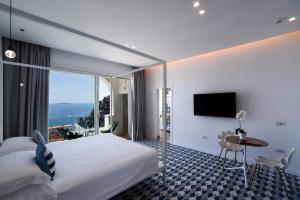 a hotel room with a bed and a large window at Hotel Montemare in Positano +37 photos