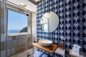 a bathroom with a sink and a mirror at Hotel Montemare in Positano