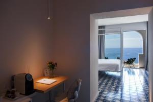 a bedroom with a bed and a view of the ocean at Hotel Montemare in Positano