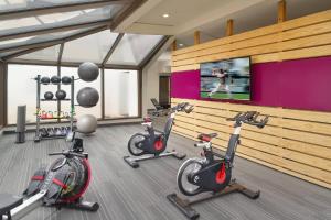a gym with three exercise bikes in a room at Courtyard by Marriott Atlanta Airport South/Sullivan Road in Atlanta