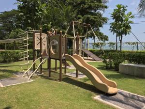 a playground in a park with a slide at By The Sea@Side Seaview n swimming pool view #133A in Batu Ferringhi