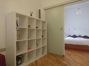 a room with a book shelf next to a bed at Apartment Rahela in Zagreb