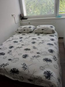 a bed with two pillows on it in a bedroom at Apartma Nadja in Maribor