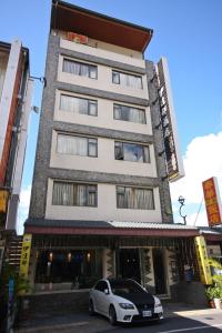 a car parked in front of a building at Itathao Vacation Hotel in Yuchi