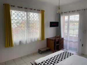 - une chambre avec 2 lits, une commode et une fenêtre dans l'établissement VILLA ESPOIR # Joyau secret # commodités # confort # prox centre ville, à Antananarivo