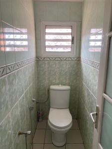 a small bathroom with a toilet and a window at VILLA ESPOIR # Joyau secret # commodités # confort # prox centre ville in Antananarivo