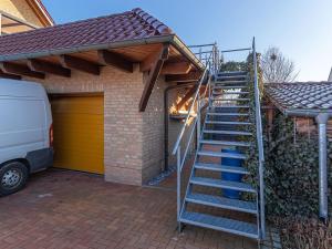 a metal staircase leading to a house with a garage at Sonnendeck im Luftkurort Klink in Klink