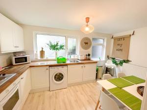 a kitchen with a sink and a dishwasher at Cottage by Rhigos Mountains in Treherbert
