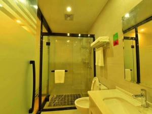 a bathroom with a shower and a toilet and a sink at Geli Hotel Xuzhou Government Olympic Sports Center in Xuzhou