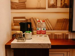 a kitchen counter top with two bottles of ketchup at GEM Hotel Bozhou College in Bozhou