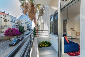 a balcony with a view of a city street at My TLV City suite in Tel Aviv