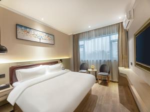 Ένα ή περισσότερα κρεβάτια σε δωμάτιο στο Gya Hotel Suzhou Hanshan Temple Binhe Road +18 φωτογραφίες
