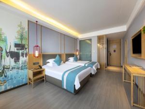 Postel nebo postele na pokoji v ubytování GreenTree Eastern Hotel Jiaxing Jiangnan Moore Store