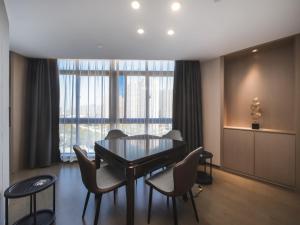 a dining room with a table and chairs and a large window at GreenTree Eastern Hotel Dezhou Qingyun Yingcai Road Financial Building in Dezhou