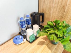 a table with a bottle of water and a plant at GreenTree Inn Lanzhou Zhongchuan Airport in Hejialiang