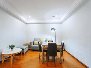 a dining room with a table and chairs and a couch at GreenTree Eastern Hotel Anshun Anshun Zhenning Huangguoshu in Zhenning