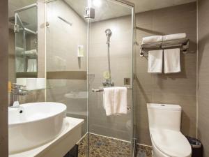 a bathroom with a toilet and a sink and a shower at GreenTree Alliance Jiangsu Huai'an Suning Plaza in Huai'an