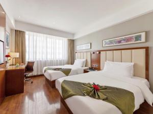 Postel nebo postele na pokoji v ubytování GreenTree Eastern Hotel Fujian Xiamen Railway Station Mingfa Plaza