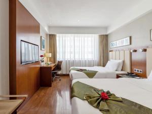 Postel nebo postele na pokoji v ubytování GreenTree Eastern Hotel Fujian Xiamen Railway Station Mingfa Plaza