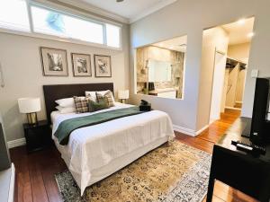 a bedroom with a large bed and a window at Mosman Park Luxury Family Home with Pool & Alfresco Dining in Fremantle +23 photos