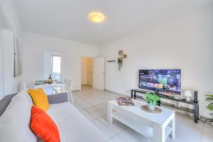 a living room with a couch and a tv at Central Love - Happy Rentals in Lugano