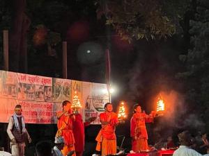 Bhurkīā的住宿－Good Karma Homestay，一群人站在一个有火的舞台上