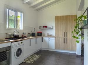 a kitchen with a washer and dryer in it at Private House for Vacation, Castel in Lamentin