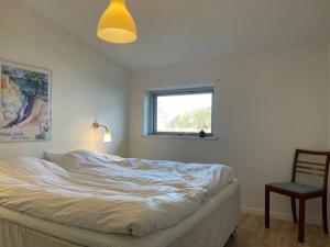 ein Schlafzimmer mit einem Bett, einem Stuhl und einem Fenster in der Unterkunft Pia´s Guesthouse in Askeby