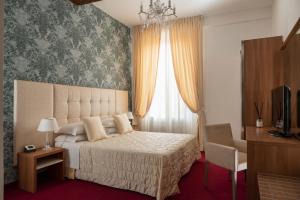 Postel nebo postele na pokoji v ubytování Albergo Rossini 1936 + 37 fotografií