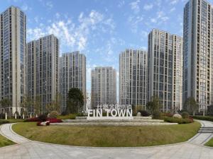 a park with a sign in front of tall buildings at GreenTree Eastern Hotel Yiwu International Trade City in Yiwu