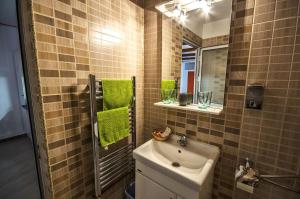 a bathroom with a sink and a mirror at NEUSTADT Villa in Braşov +24 photos