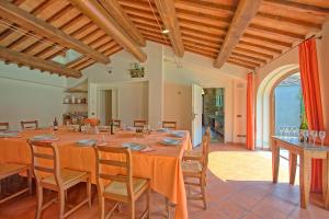 a large dining room with a long table and chairs at Santa Flora by PosarelliVillas in Capolona