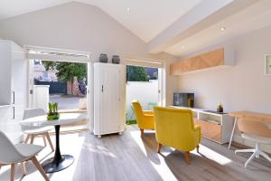 a kitchen and dining room with yellow chairs and a table at 1 bedroom flat in centre of Odiham- free parking in Odiham