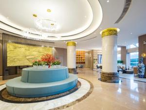 a lobby with a round blue table in a building at GreenTree Eastern Hotel Wuhan Optics Valley East Lake Wuhan University in Wuhan