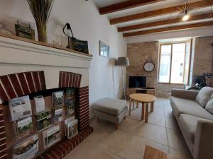 a living room with a couch and a table at Maison plein centre COULON MARAIS POITEVIN in Coulon