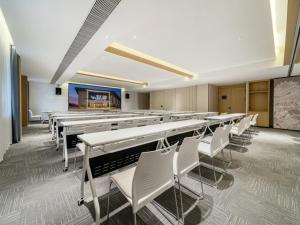 una classe con file di tavoli e sedie bianche di GreenTree Eastern Hotel Nanjing Jiangning University a Jiangning Altre 31 foto