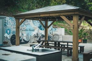 a wooden gazebo with a picnic table in front of a wall at Little Hermit - Vacation STAY 39645v in Tateyama