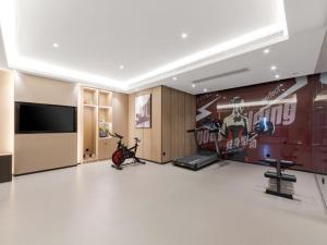 a room with a gym with a bike and a tv at GreenTree Eastern Hotel Wuhan Optics Valley East Lake Wuhan University in Wuhan