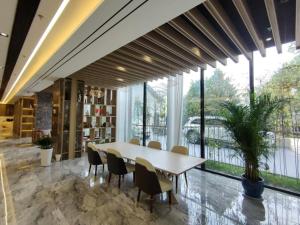 a table and chairs in a room with a large window at GreenTree Eastern Hotel Huai'an Suning Plaza West Huaihai Road in Huai'an